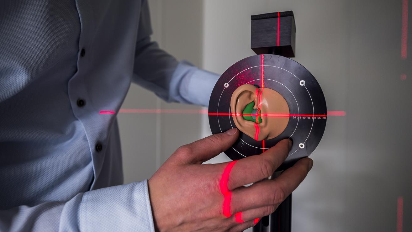 Laser zeigt auf Zielscheibe mit künstlichem Ohr